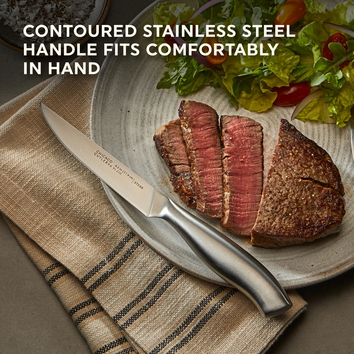 Insignia Steel Steak Knife Set on plate with text contoured stainless steel handle fits comfortably in hand