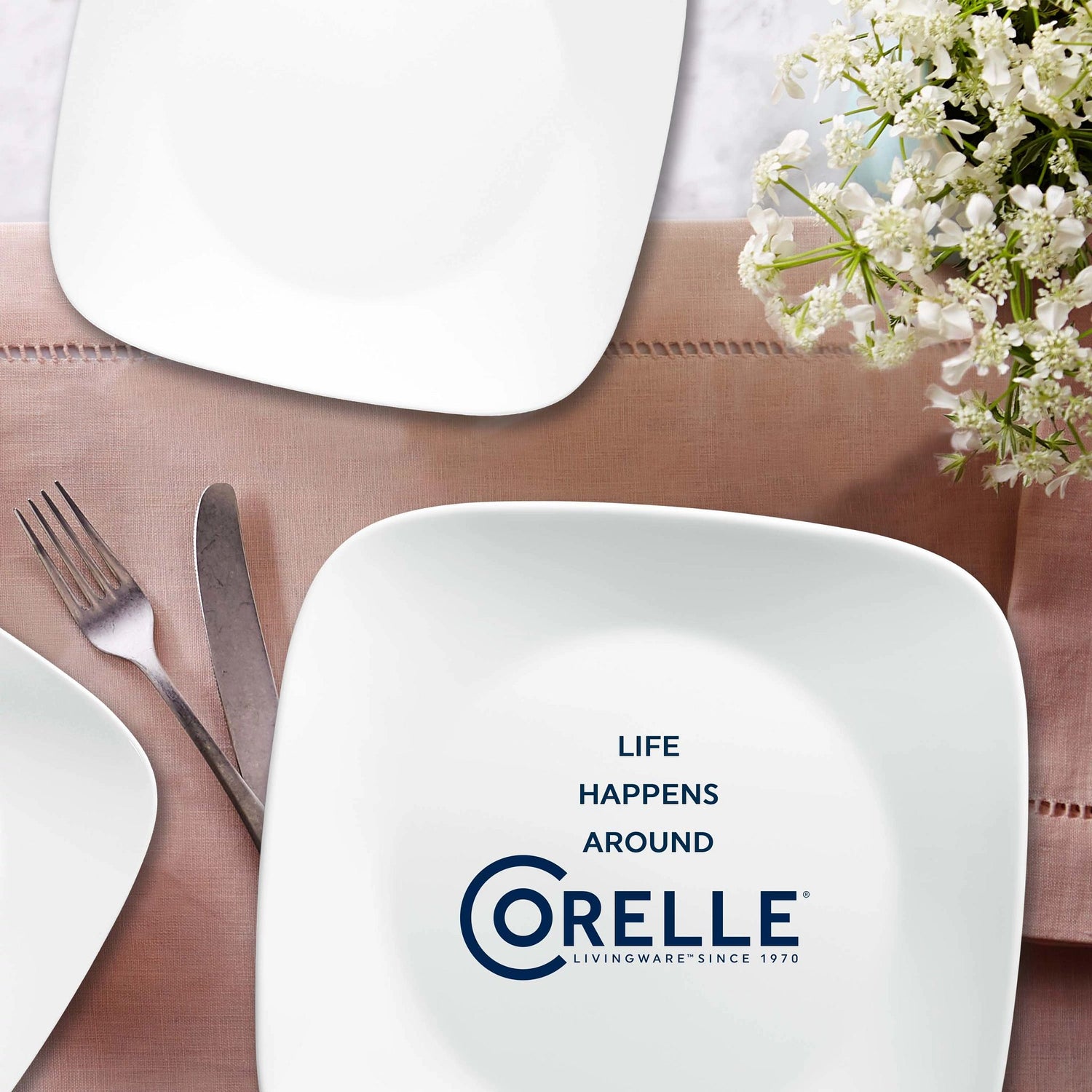 Vivid White dinnerplates on the table with text life happens around Corelle