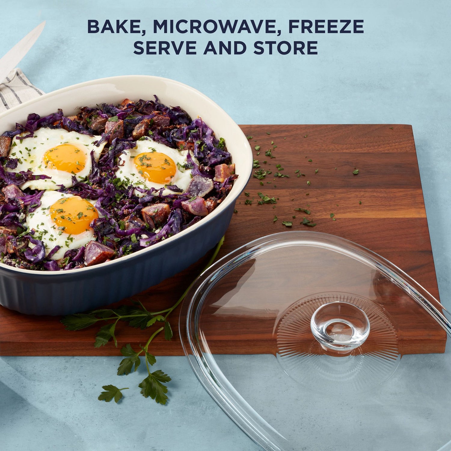 French Colors 2.5-quart Oval Baking Dish, Navy on a counter with food and text on photo bake, microwave, freeze, serve & store