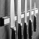 Chicago Cutlery 18" Magnetic Strip on the wall with several knifes on it