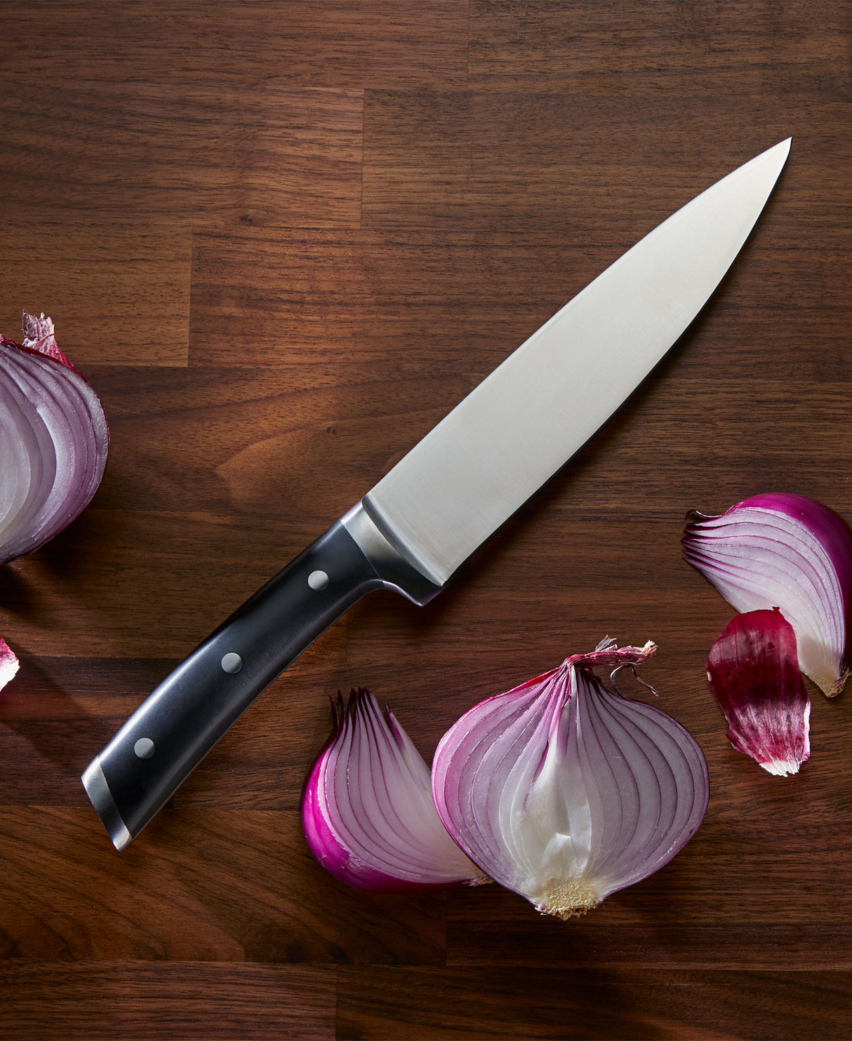 Damen Chef Knife on cutting board with onion