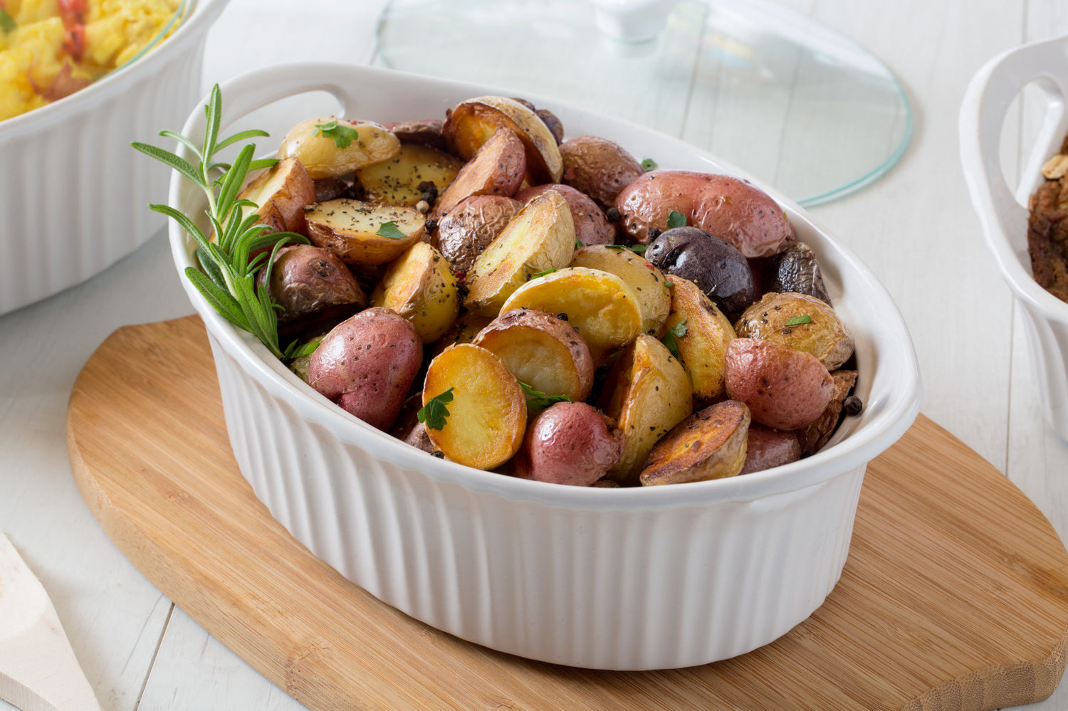 Corningware French White 1.5-qt Oval  (with lid) with baked potatoes inside