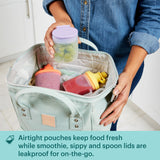 Baby Littles being put in togo bag with text airtight pouches keep food fresh while smoothie, sippy & spoon lids are leakproof for the on-the-go