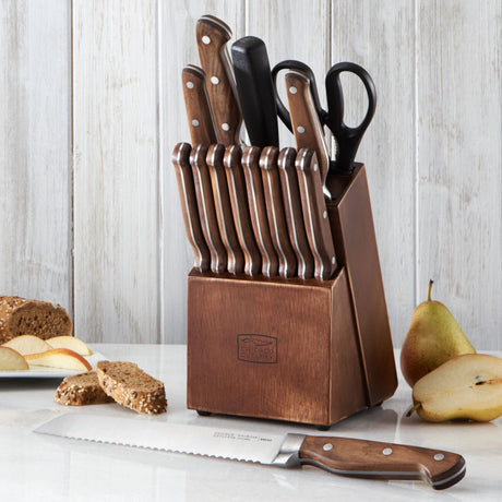  Precision Cut 15-piece Block Set on counter with serrated bread knife laying in front of it and apples &amp; bread on the side