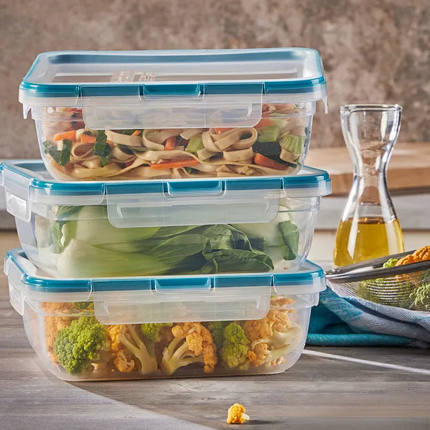  Total Solution® 6-piece Rectangular Plastic Food Storage Set with food inside on the counter with salad oil on the side