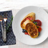  Madeline Embossed Dinnerplate with fruit and toast on it